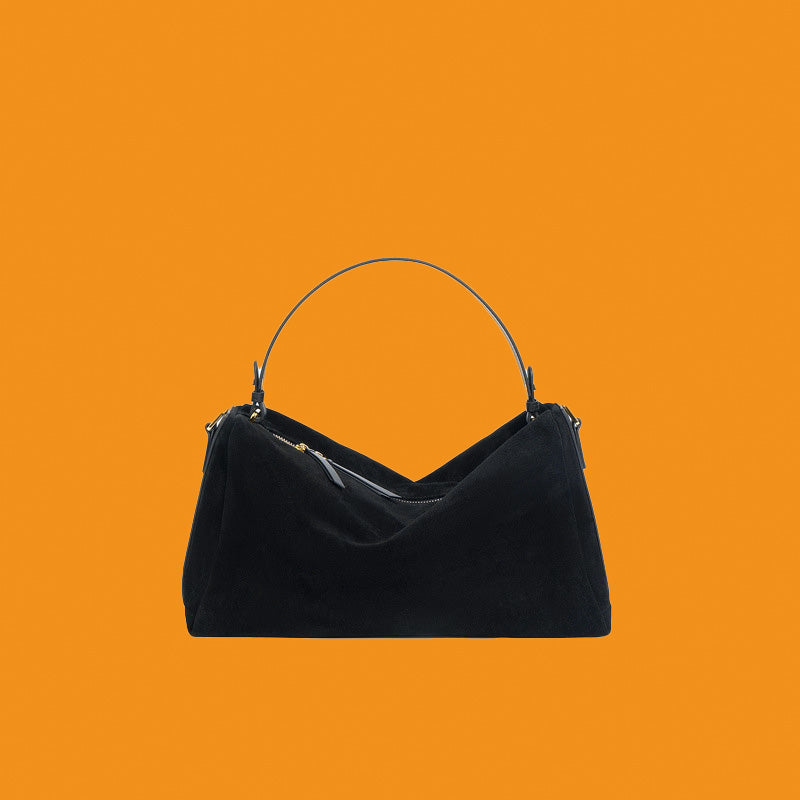 Black handbag on an orange background