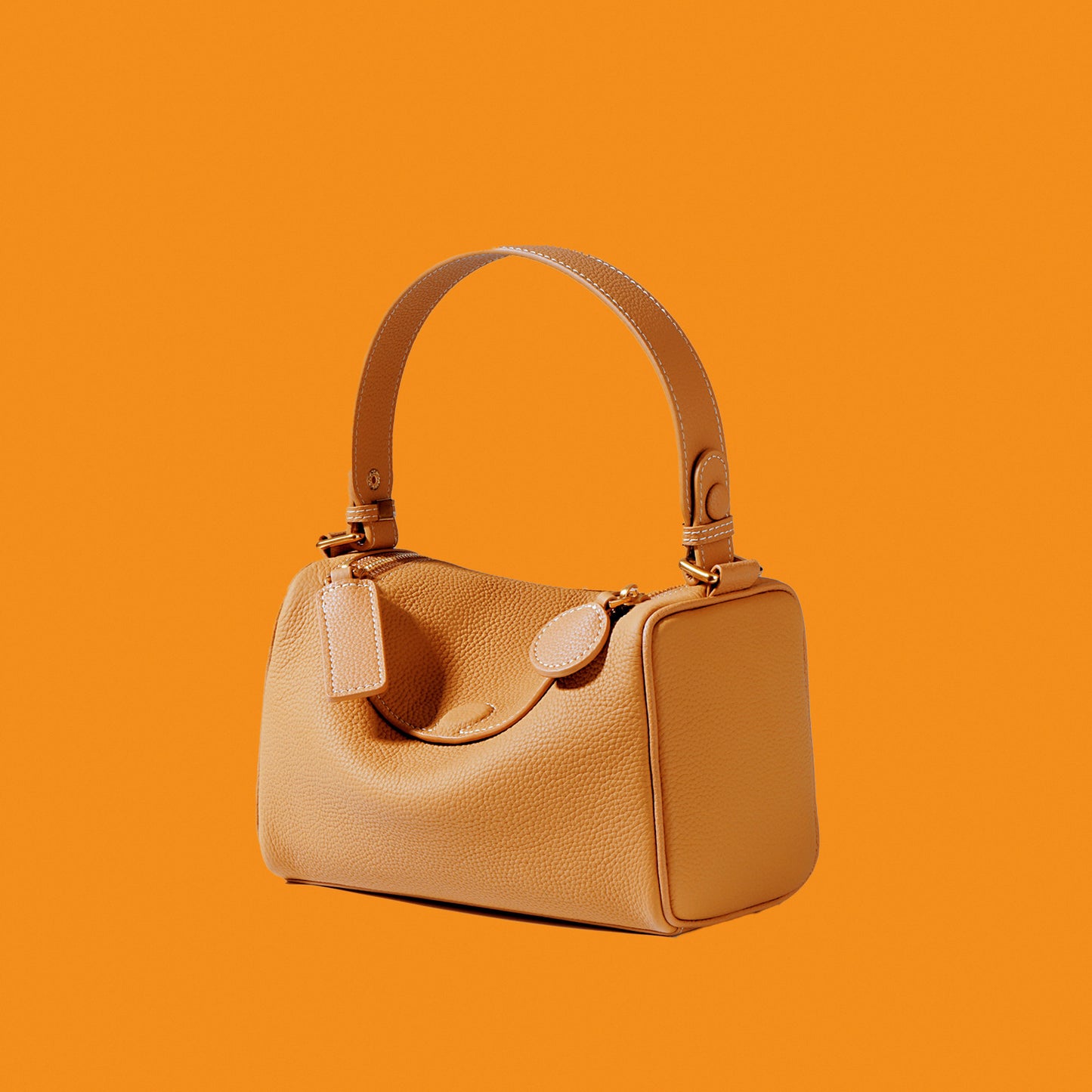 Beige handbag on an orange background
