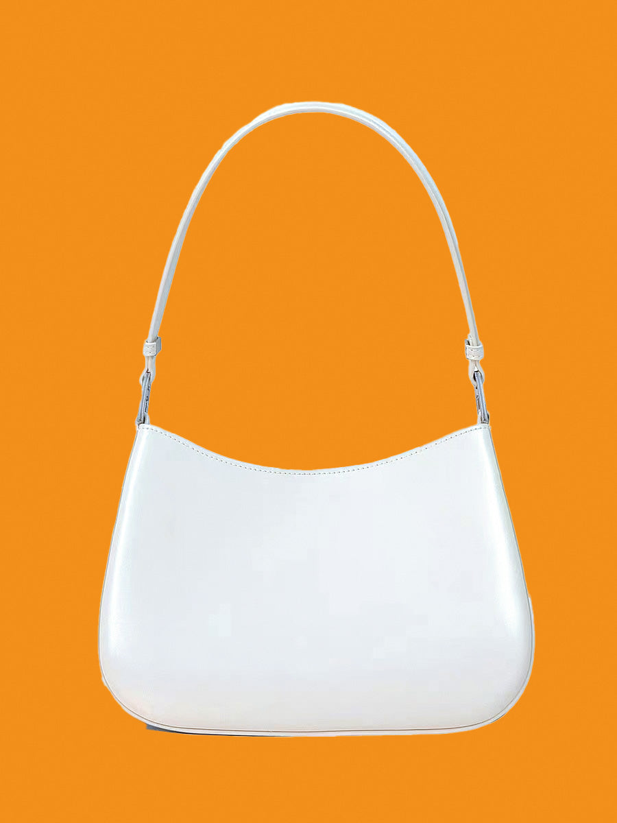 White handbag on an orange background