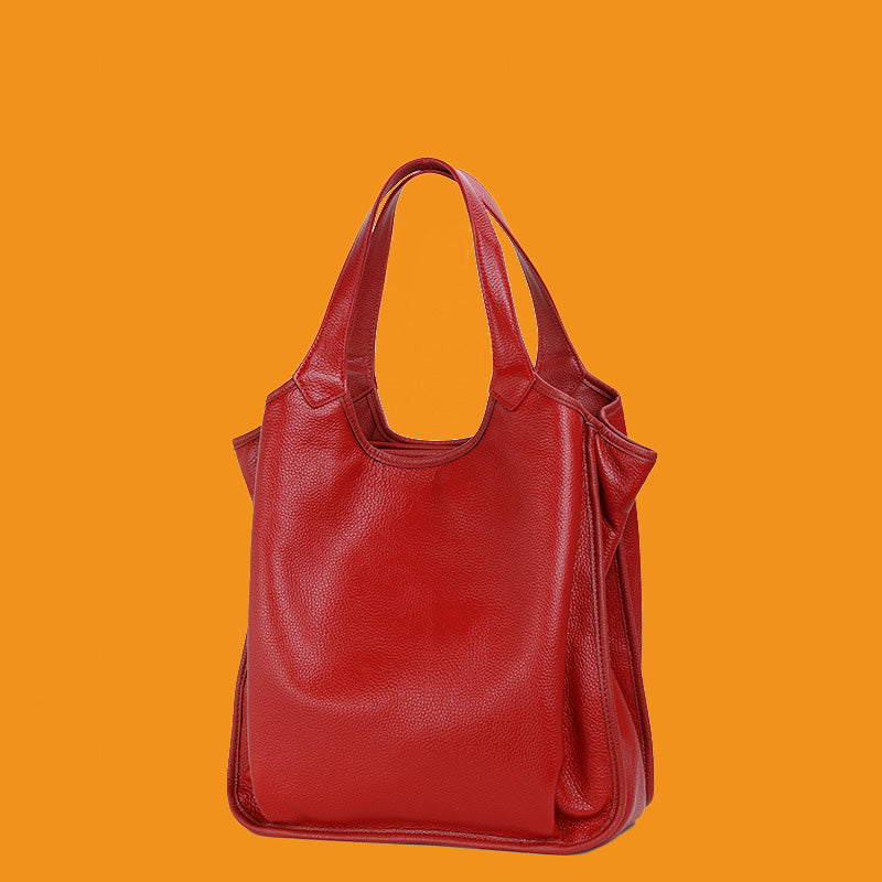 Red leather handbag on an orange background