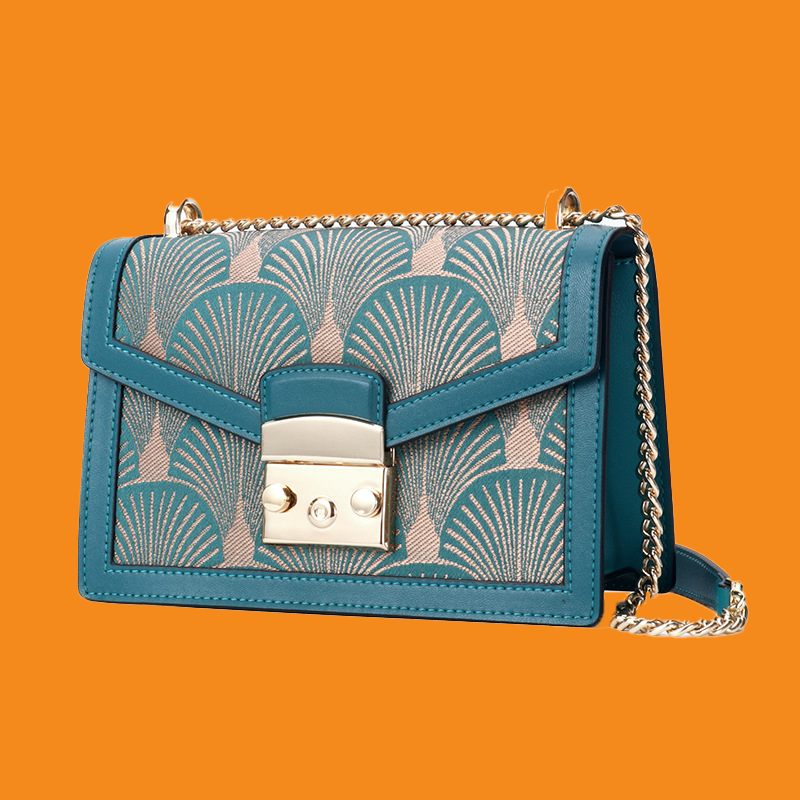 Blue handbag with a patterned design on an orange background