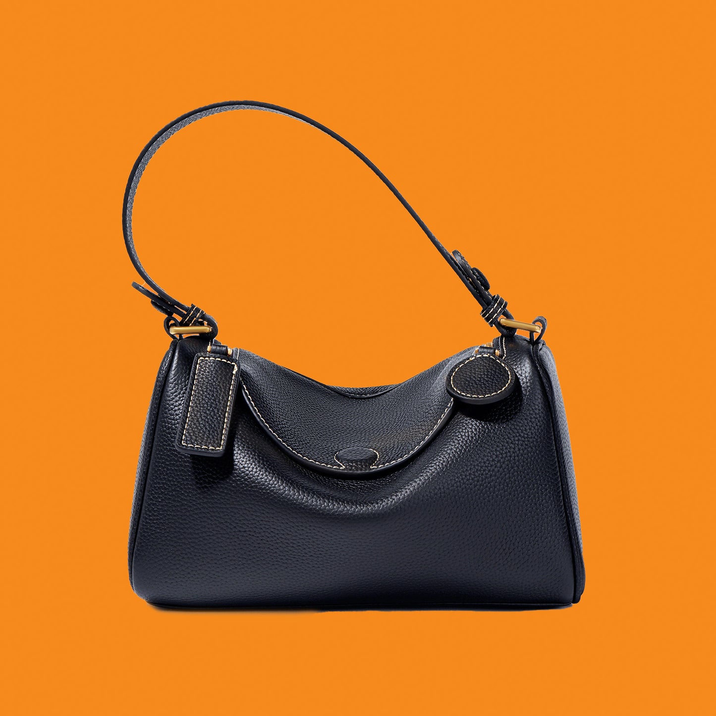 Black handbag on an orange background