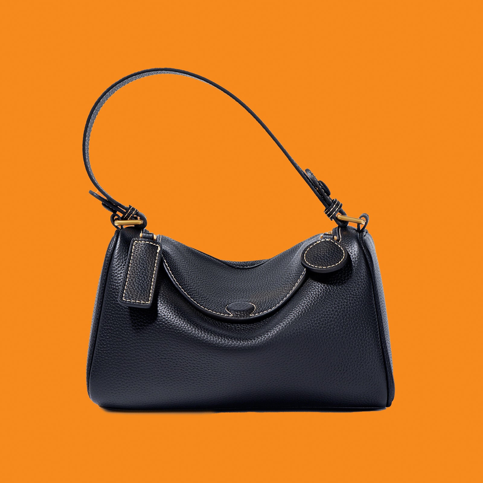 Black handbag on an orange background