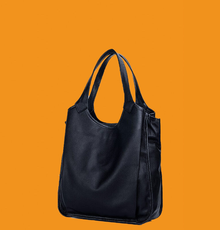 Black handbag on an orange background