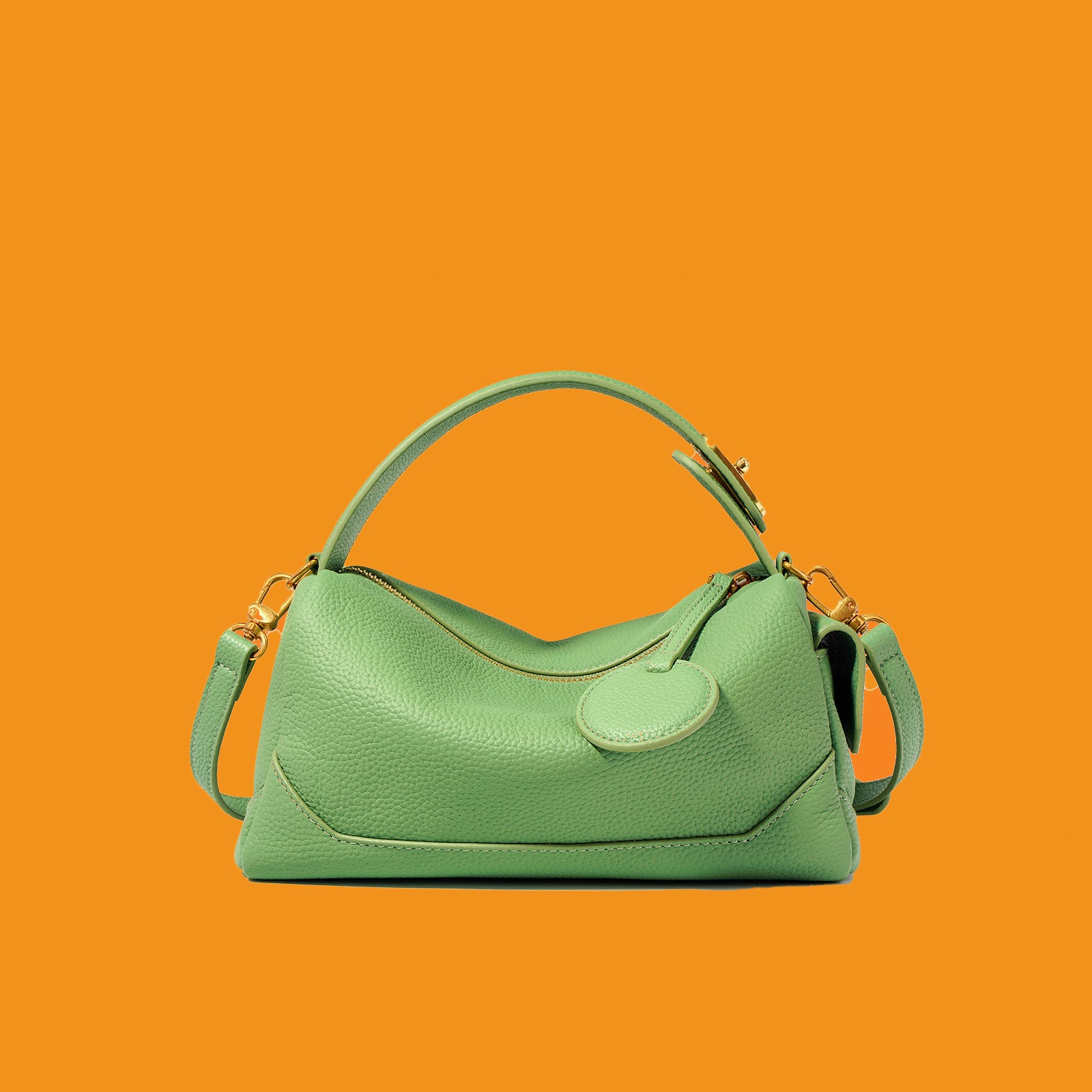 Green handbag on an orange background
