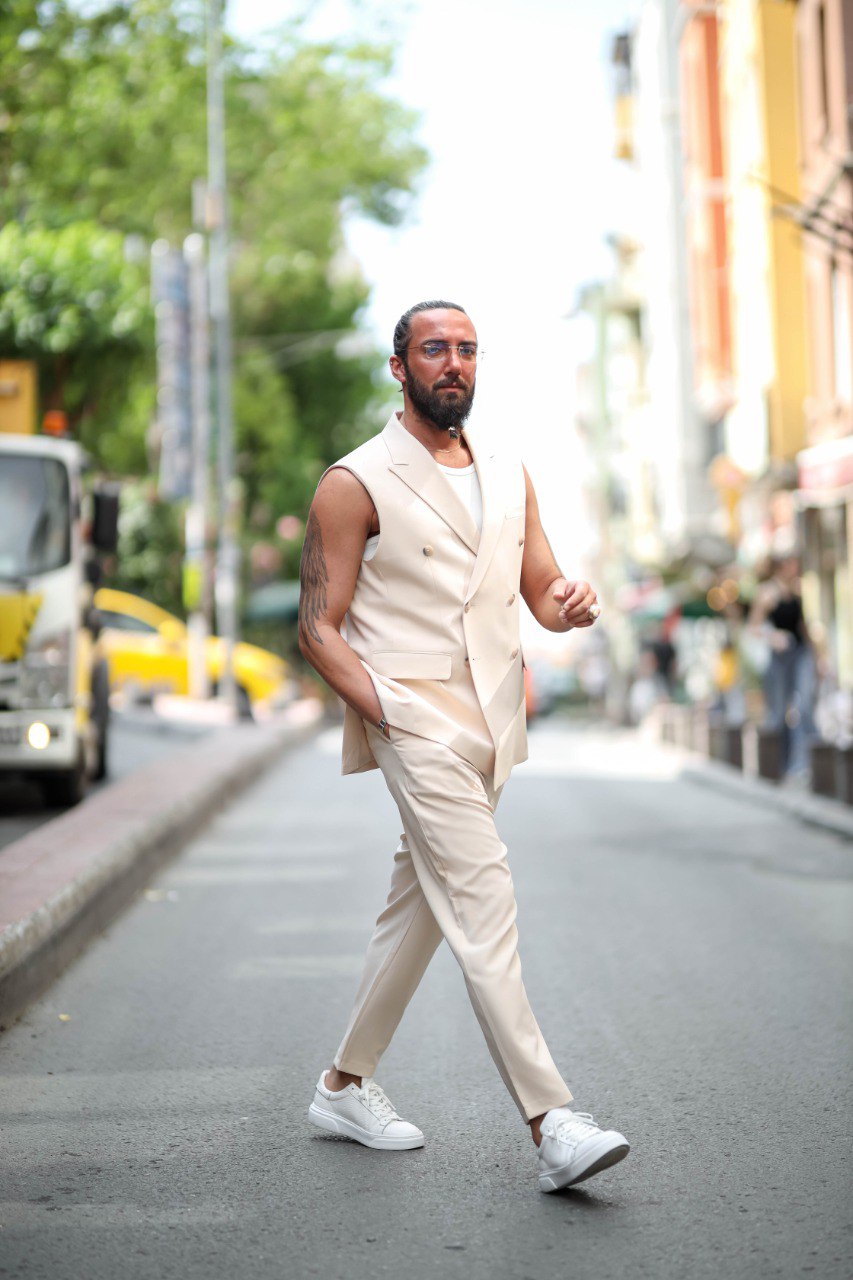 Man in a beige suit walking on a city street